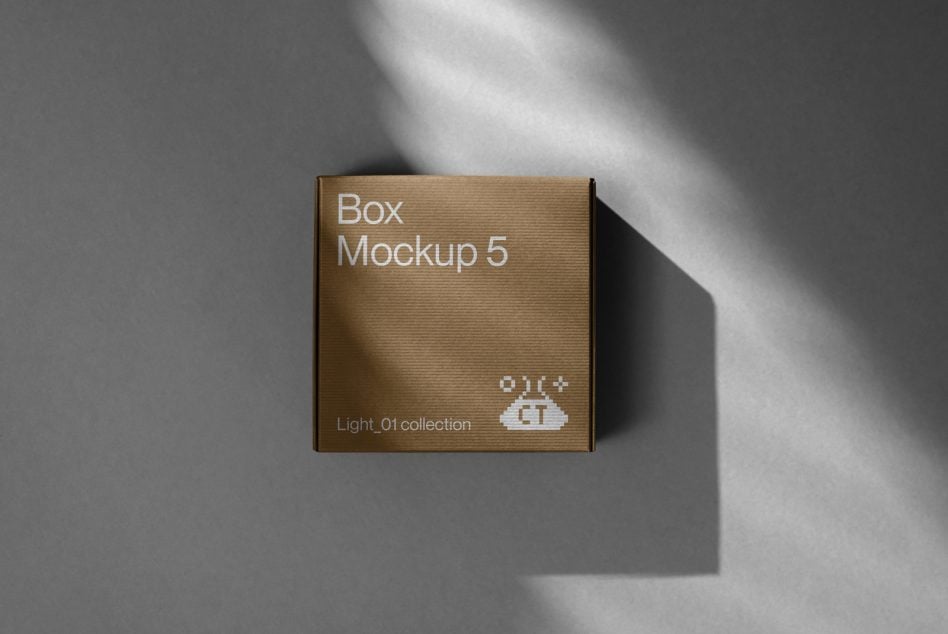 Kraft brown corrugated box with white text on gray surface